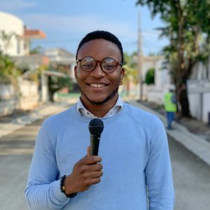 Reporter on location in street.